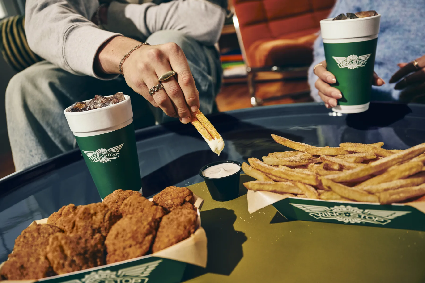 Official Wingstop lifestyle photo of boneless wings and seasoned fries