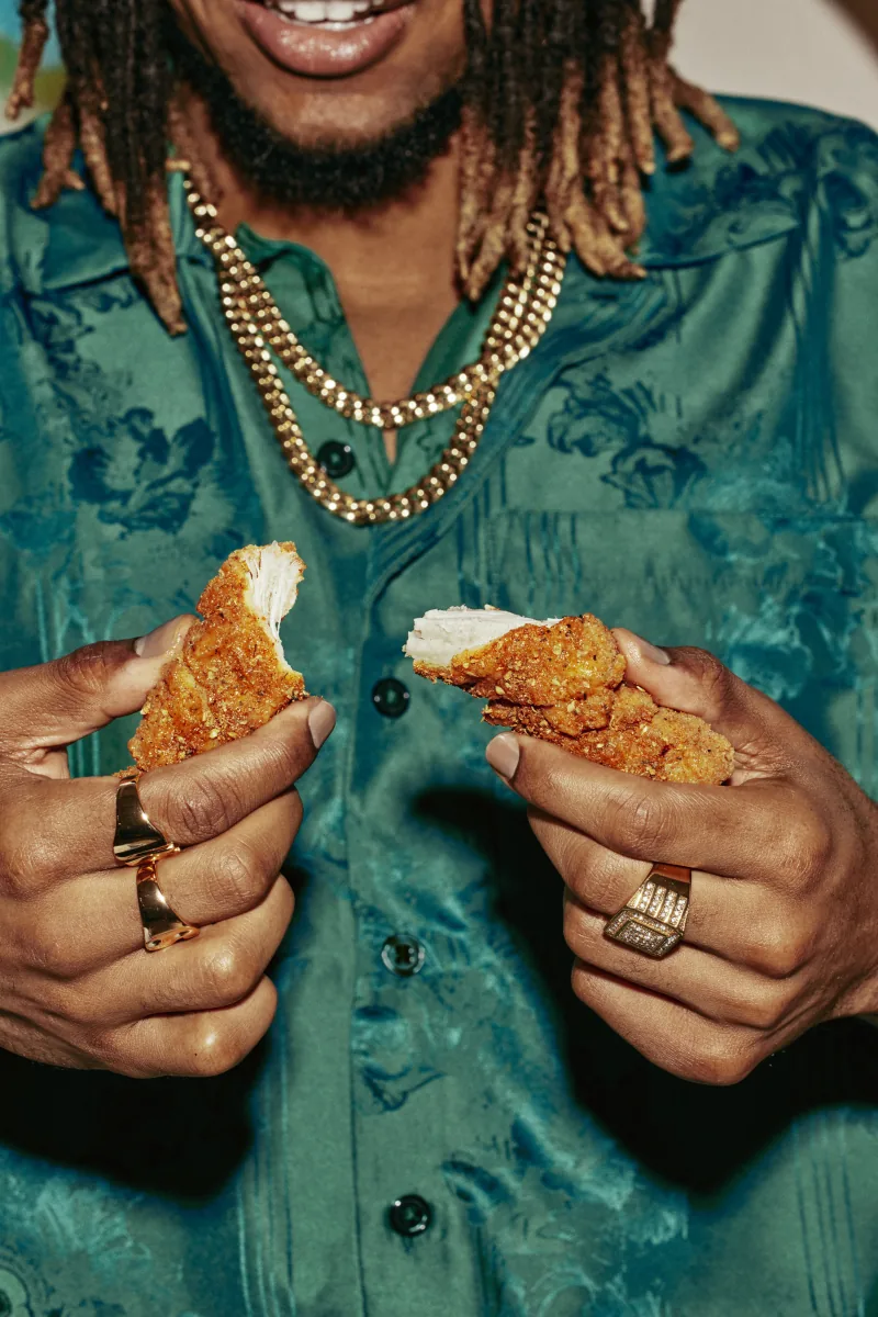 Official vertical Wingstop photograph of crispy tenders and dipping sauce